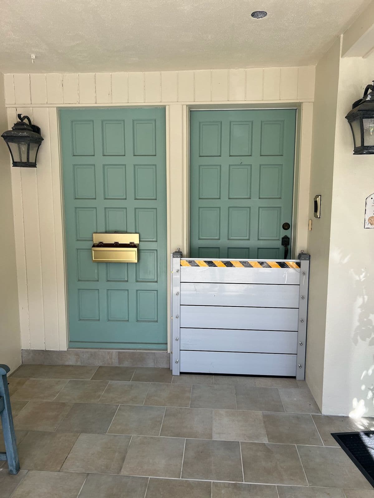 Aluminum flood barrier sealing a teal double-door entry