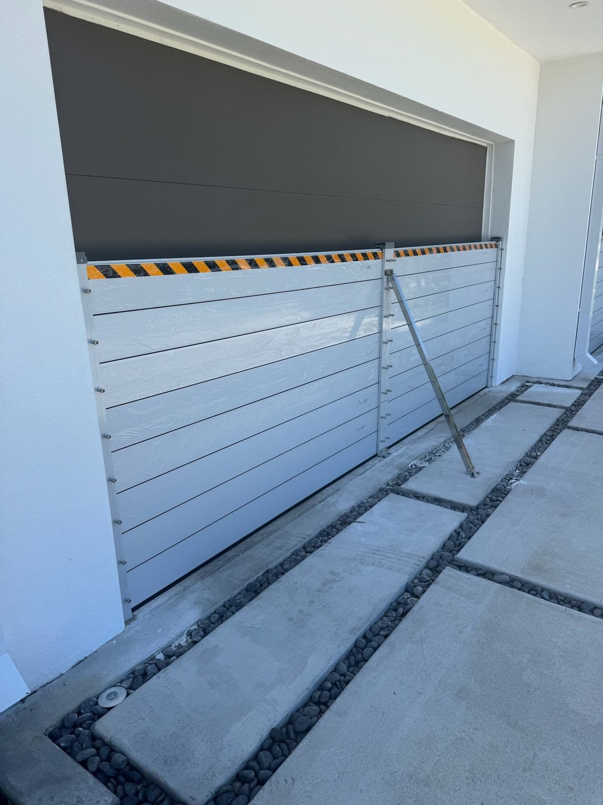 Tall aluminum flood barrier across a garage opening