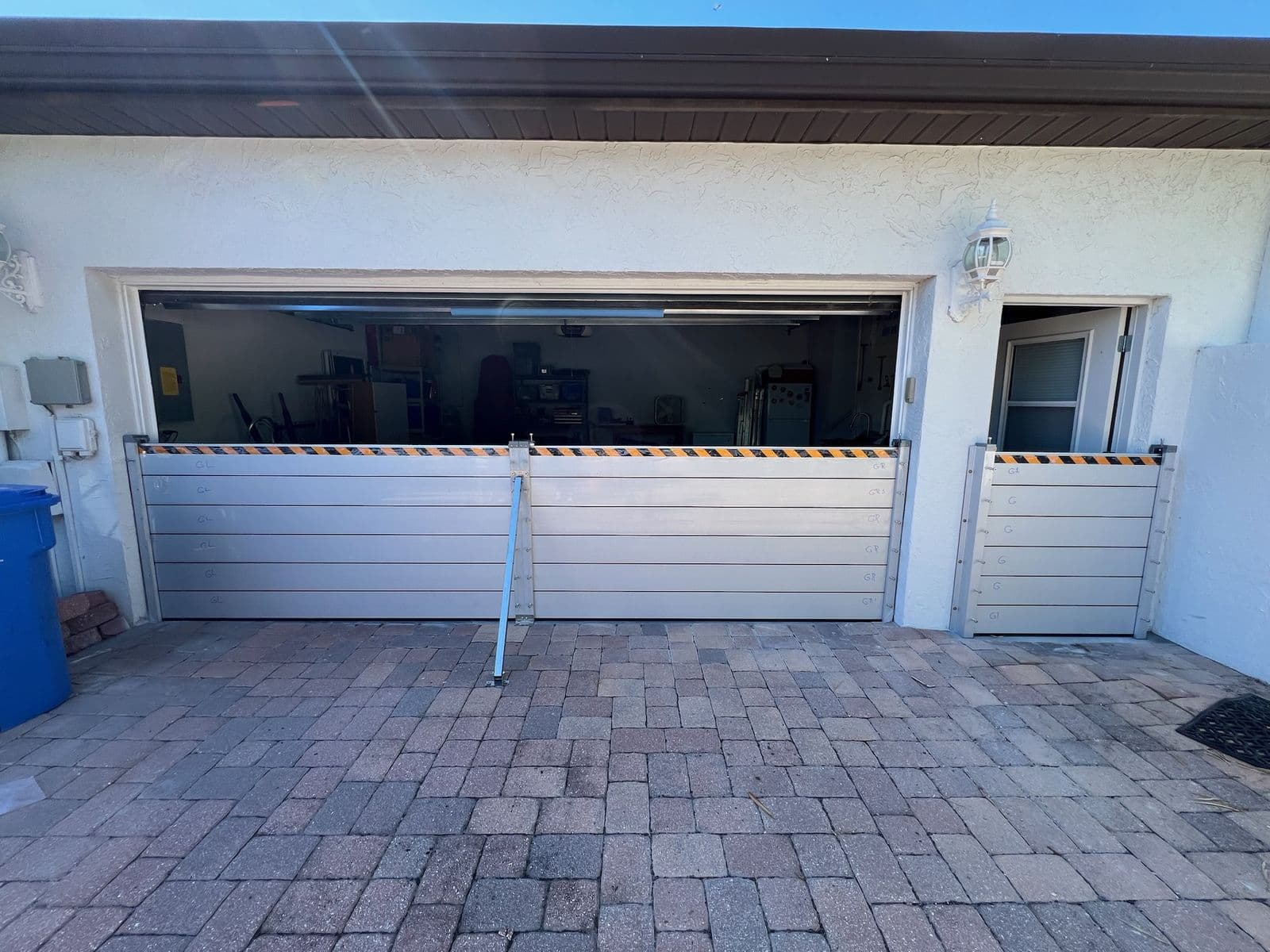 Flood barriers protecting a double garage and side door