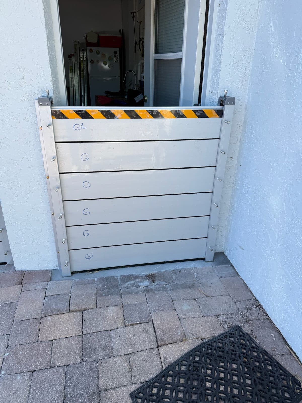 Custom-fit flood barrier protecting a residential doorway